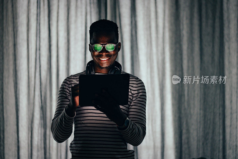 Smiling BusinessmanÂ Working At Home On A Digital Tablet